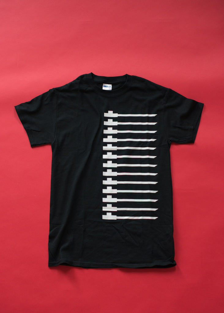 Traditional pipe design on black soft cotton t-shirt. White on black.