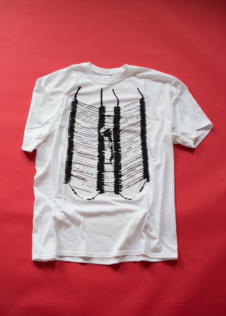 White tshirt with silkscreened artwork of a breast plate worn by male powwow dancers.