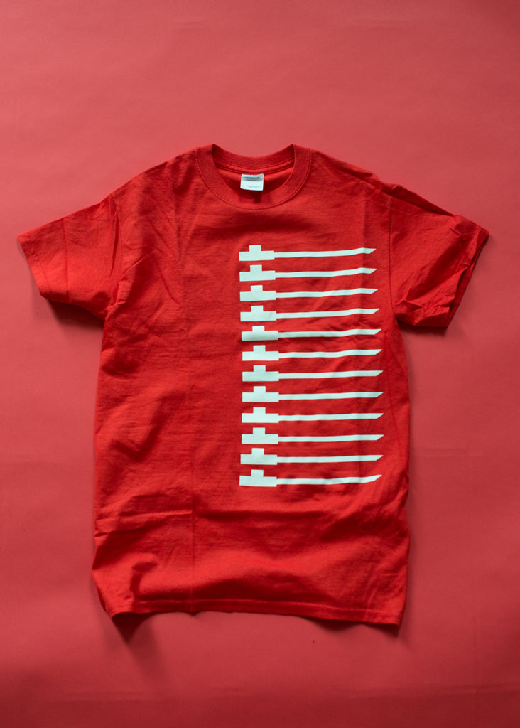 Traditional pipe design on red soft cotton t-shirt. White on red.