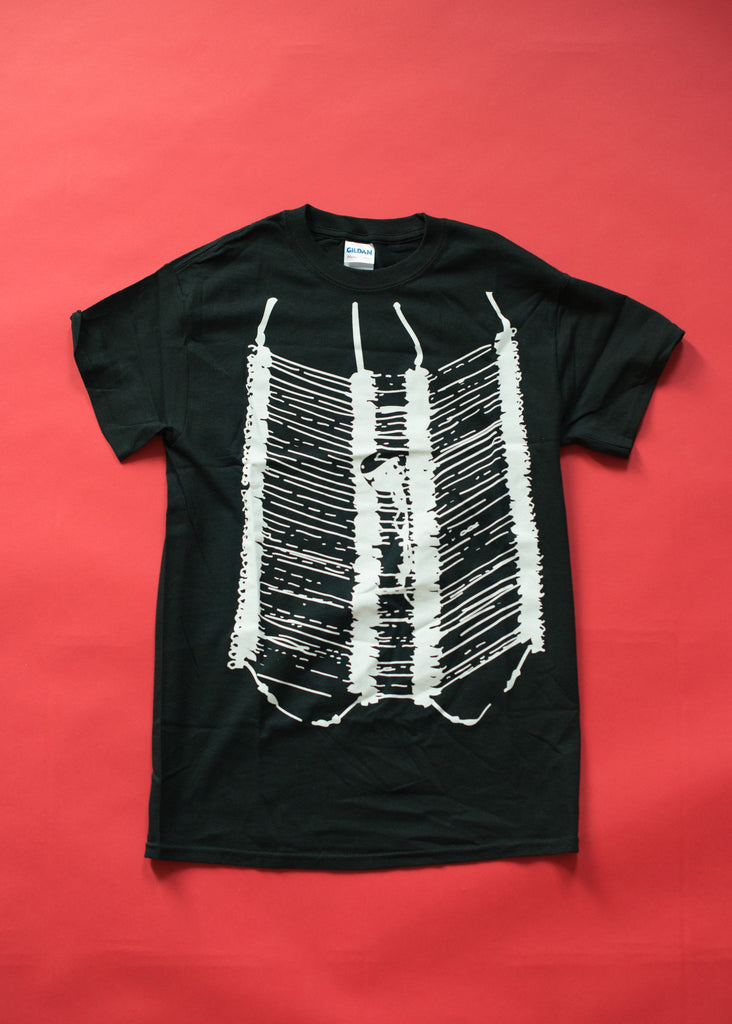 Black tshirt with silkscreened artwork of a breast plate worn by male powwow dancers.